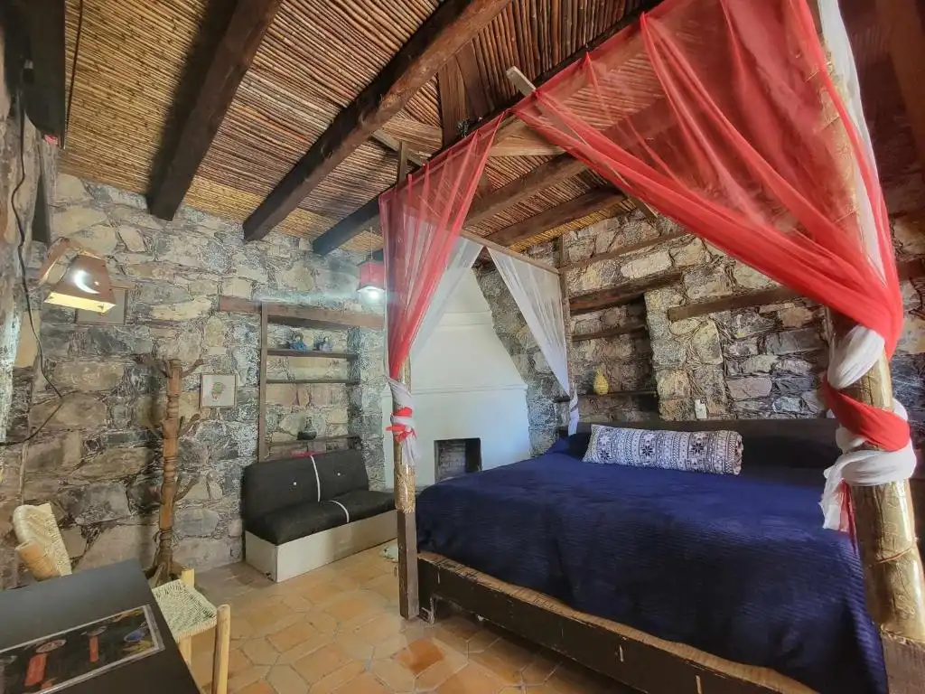 Rustic guest room with canopy bed