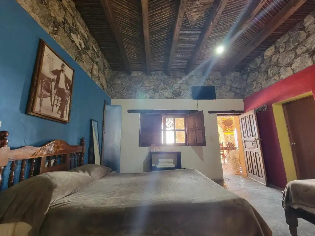 Traditional guest room with stone walls